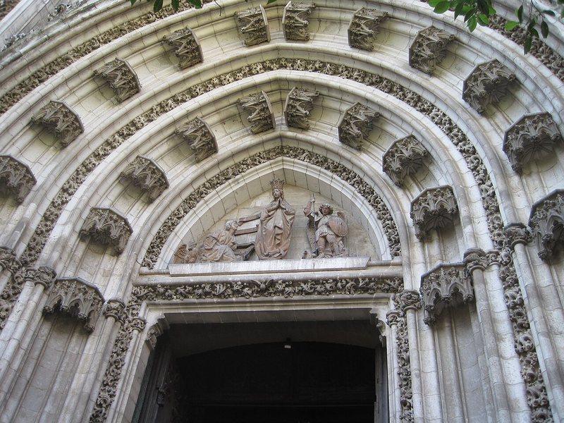 A carved stone doorway of the cathedral, its archivolts layered around a relief.