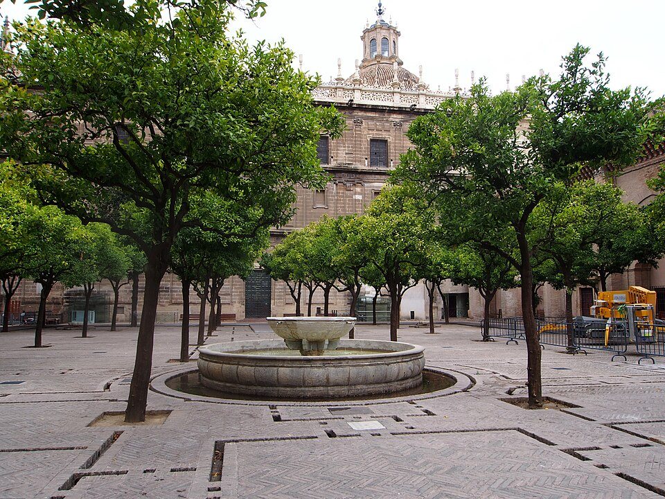 The central fountain of the Patio de los Naranjos, among its orange trees.